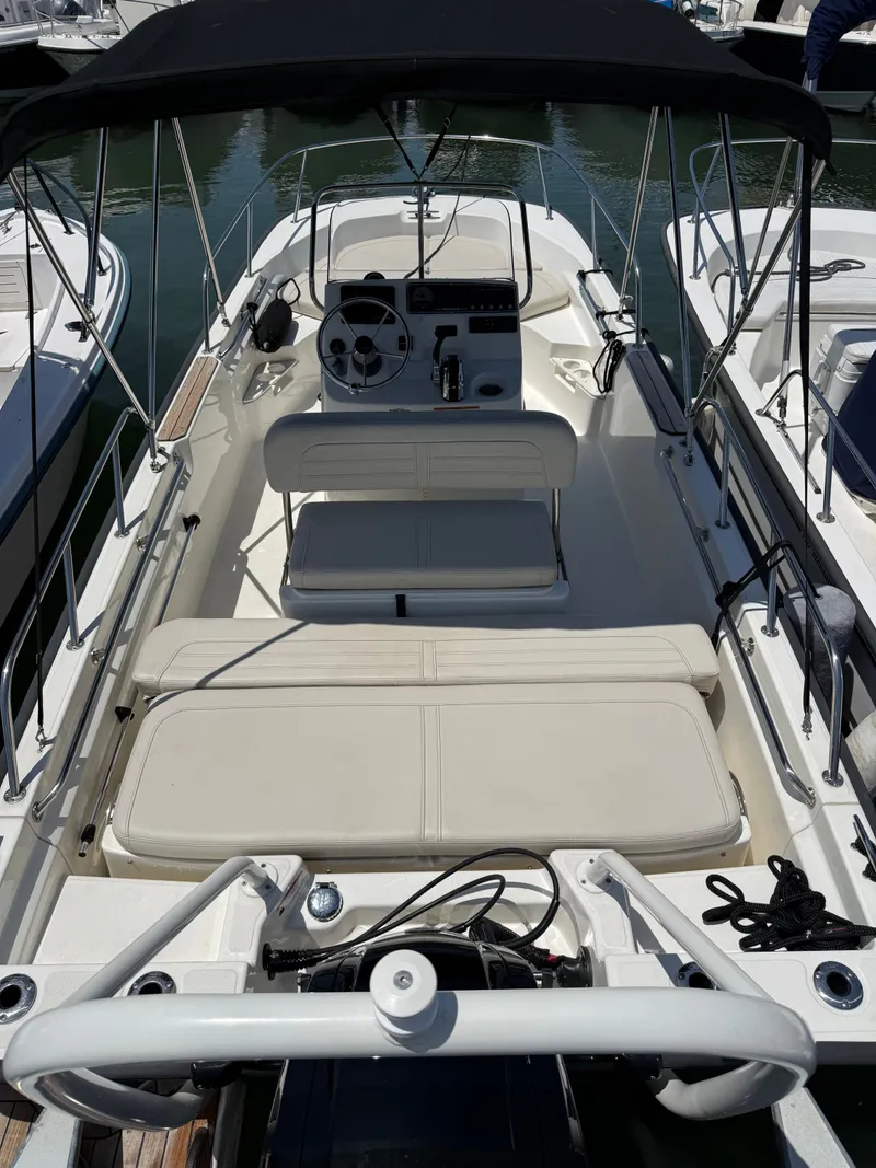 Slide: The Image of The image shows a 2022 Boston Whaler 170 Montauk boat with a simple, open deck layout. - 7