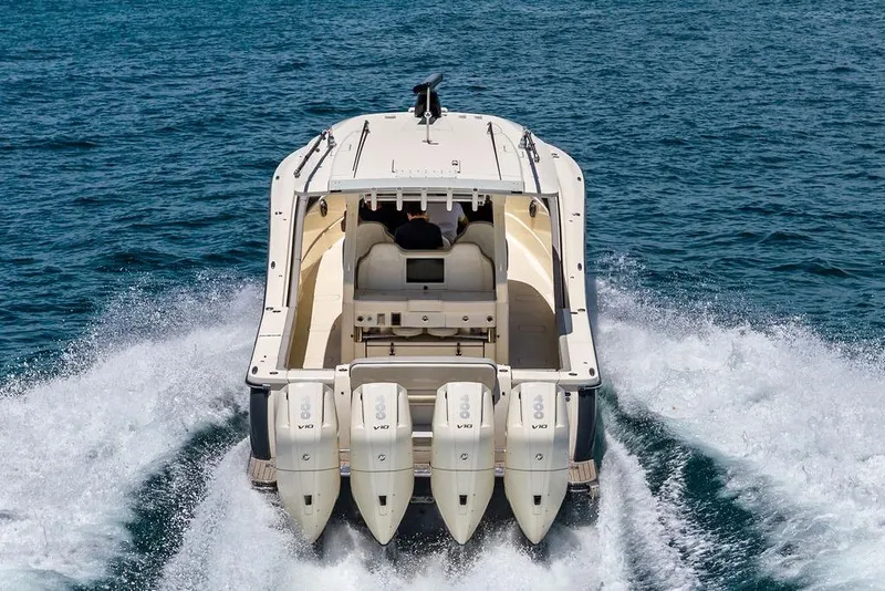 Slide: The Image of 2021 Scout 425 LXF boat cruising on open water, rear view. - 8