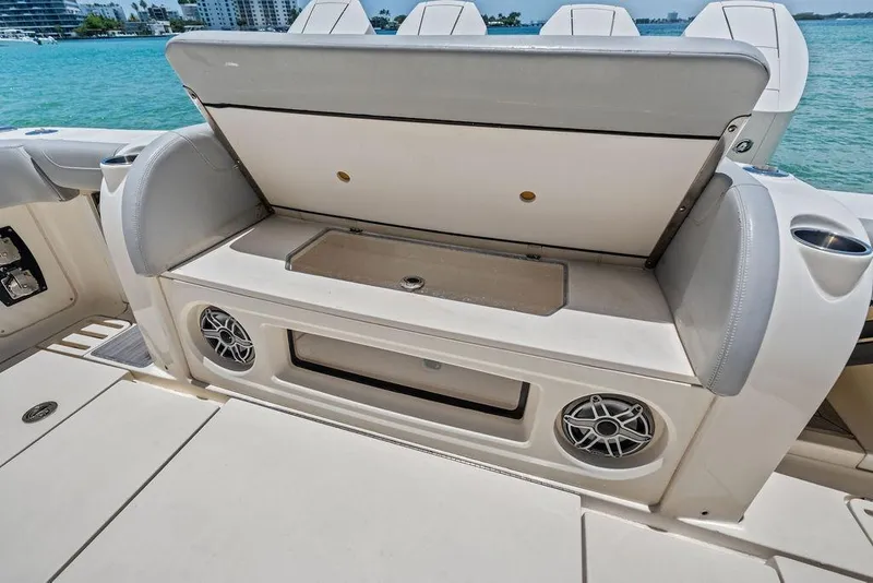 Slide: The Image of 2021 Scout 425 LXF boat interior with open storage compartment and speakers. - 24