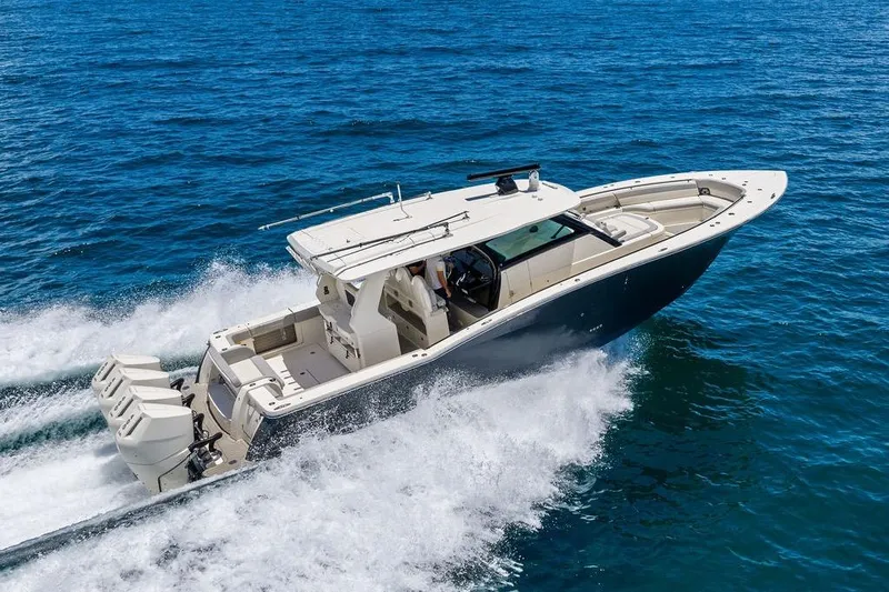 Slide: The Image of 2021 Scout 425 LXF boat cruising on open blue water. - 9