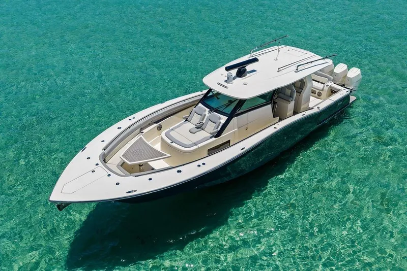 Slide: The Image of 2021 Scout 425 LXF boat on clear turquoise water, showcasing luxury and design. - 5
