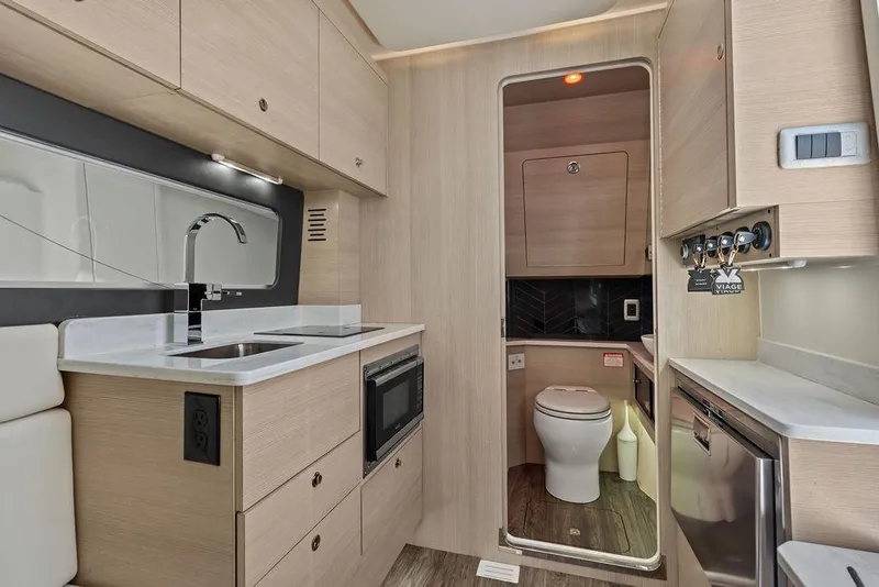 Slide: The Image of Modern kitchen and bathroom interior of 2021 Scout 425 LXF boat, featuring sleek cabinetry and fixtures. - 33