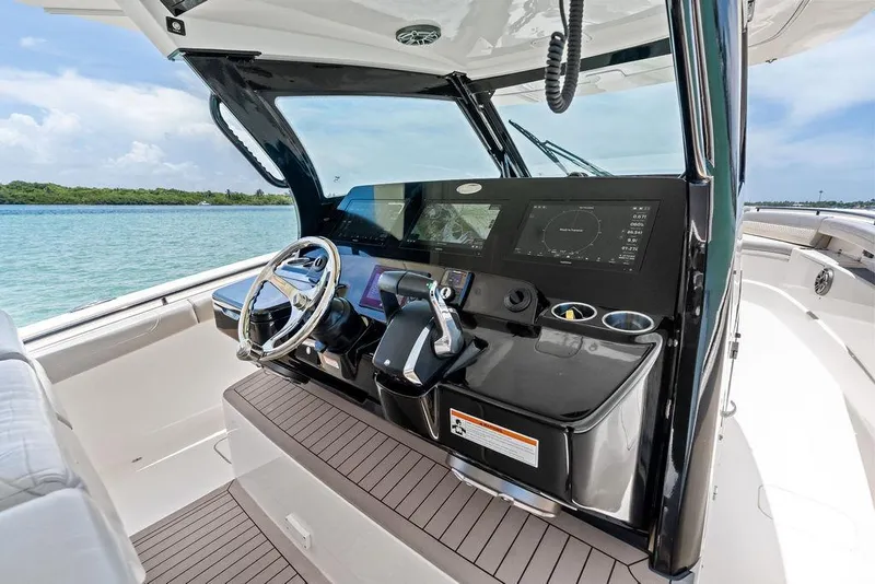 Slide: The Image of 2021 Scout 425 LXF boat helm with modern controls and navigation display. - 26