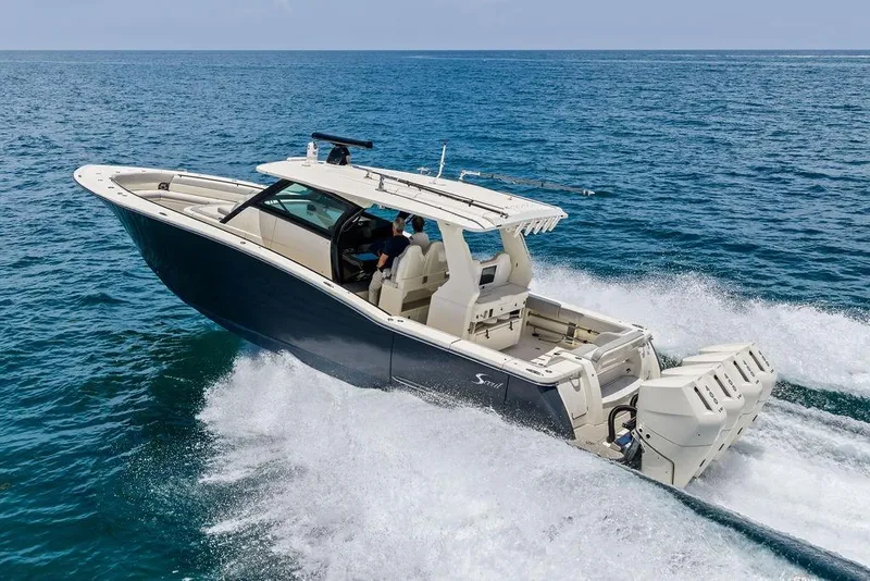 Slide: The Image of 2021 Scout 425 LXF boat cruising on open ocean waters. - 6