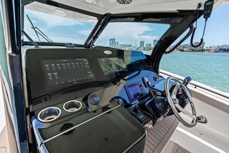 Slide: The Image of Helm of 2021 Scout 425 LXF boat with advanced navigation system and ocean view. - 29