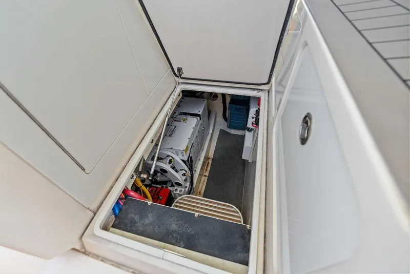 Slide: The Image of 2021 Scout 425 LXF boat storage compartment with visible equipment and wiring. - 37