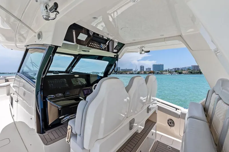Slide: The Image of Interior view of 2021 Scout 425 LXF boat with luxurious seating and modern dashboard. - 30