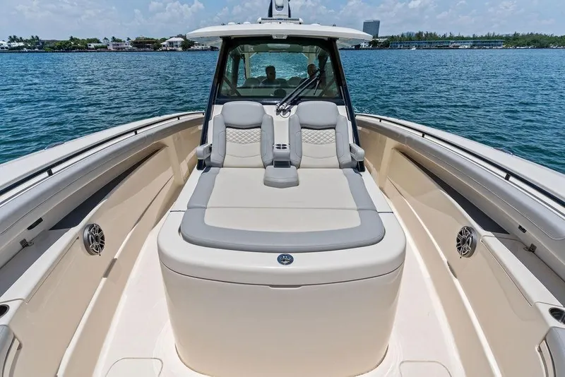 Slide: The Image of 2021 Scout 425 LXF boat interior with luxurious seating on calm water. - 14