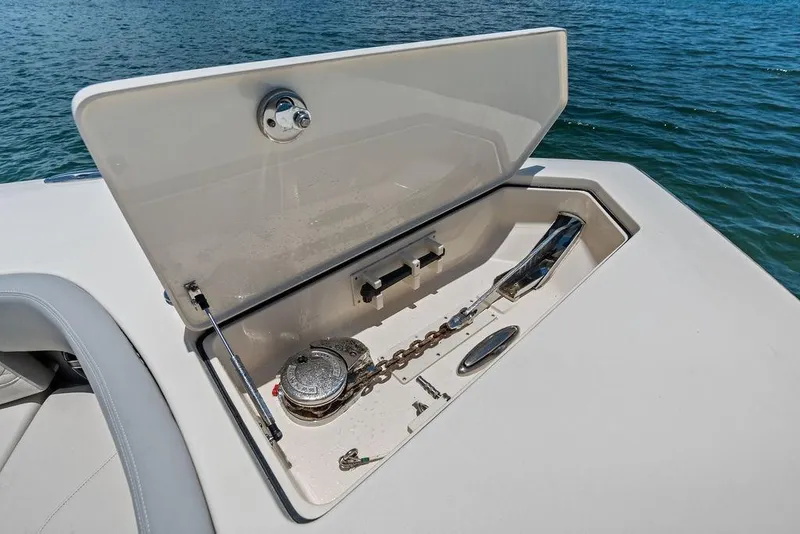 Slide: The Image of Open anchor compartment on 2021 Scout 425 LXF boat, with visible chain and winch. - 18