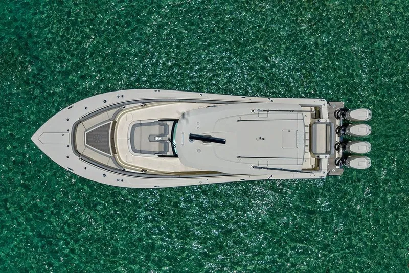 Slide: The Image of Aerial view of 2021 Scout 425 LXF boat on clear turquoise water. - 11