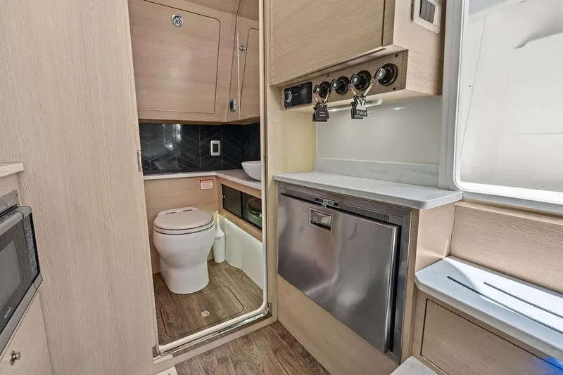 Slide: The Image of Modern bathroom and kitchenette in 2021 Scout 425 LXF boat, featuring sleek design and appliances. - 34
