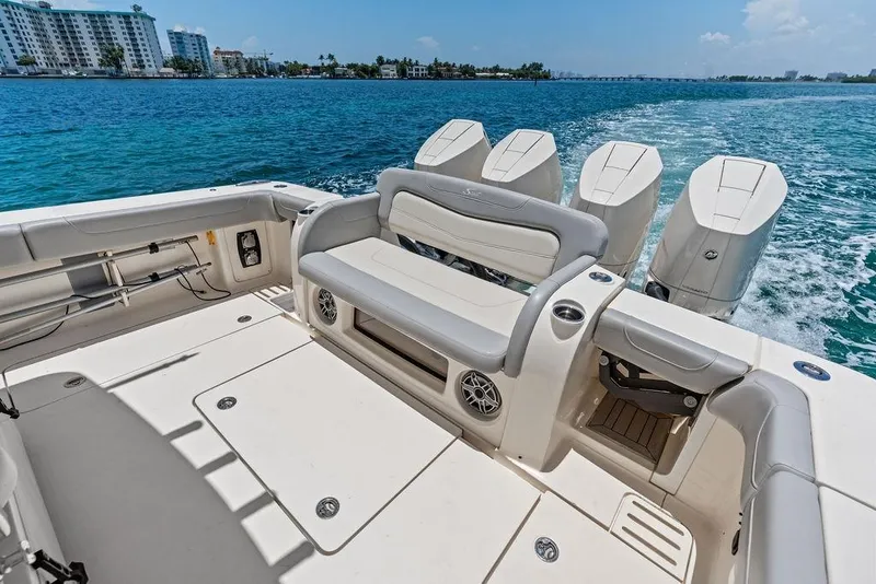 Slide: The Image of 2021 Scout 425 LXF boat interior with seating and four outboard engines on the water. - 17