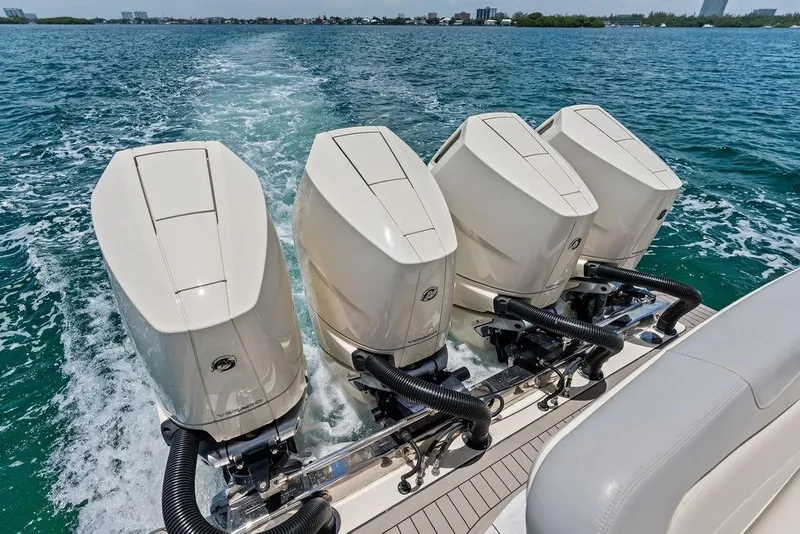 Slide: The Image of 2021 Scout 425 LXF boat with four powerful outboard engines cruising on open water. - 20