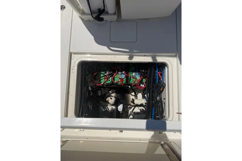 Slide: The Image of Battery compartment of a 2016 Boston Whaler 280 Outrage boat, showing wiring and components. - 13