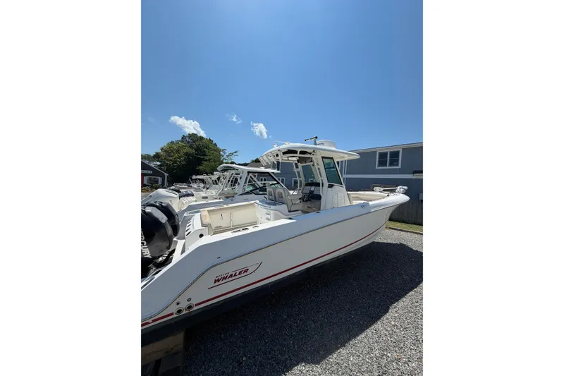 Slide: The Image of 2016 Boston Whaler 280 Outrage boat on display under clear blue sky. - 2