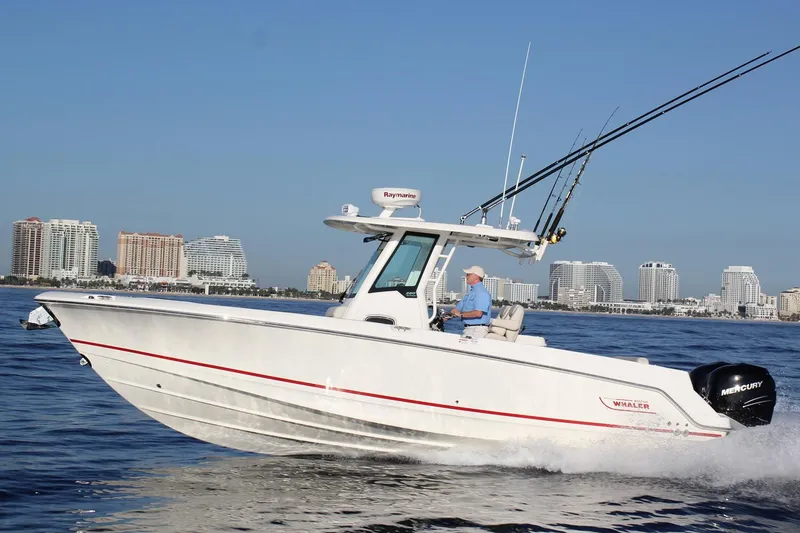 The Image of Manufacturer Provided Image: 2016 Boston Whaler 280 Outrage boat cruising on water with city skyline in background. - 0
