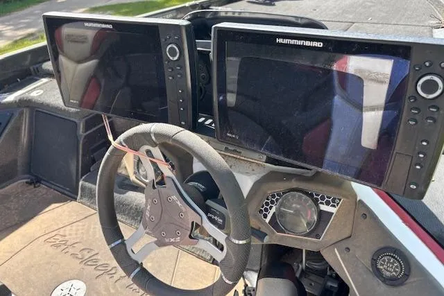Slide: The Image of 2022 Skeeter FXR21 Limited boat dashboard with dual Humminbird displays and steering wheel. - 5