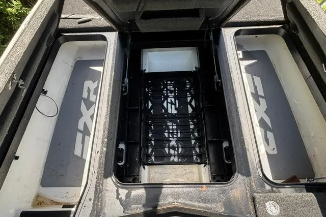Slide: The Image of 2022 Skeeter FXR21 Limited boat storage compartments, open and empty, showcasing interior layout. - 8