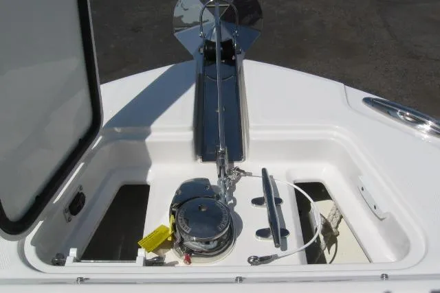 Slide: The Image of 2019 Edgewater 248CX Crossover boat anchor compartment with winch and storage. - 4