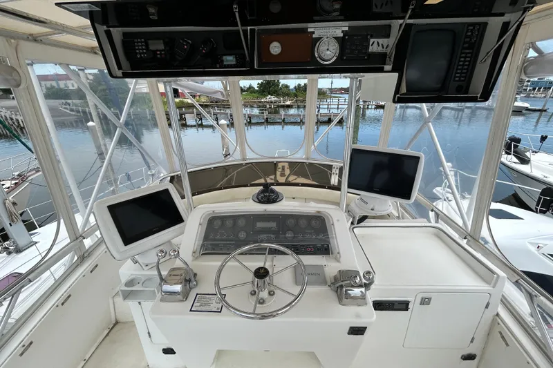 Slide: The Image of Cockpit of a 1990 Bertram 37 Convertible yacht with navigation equipment and steering wheel. - 10