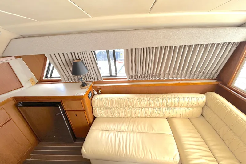 Slide: The Image of Interior of 1990 Bertram 37 Convertible yacht with cream leather sofa and wooden cabinetry. - 18