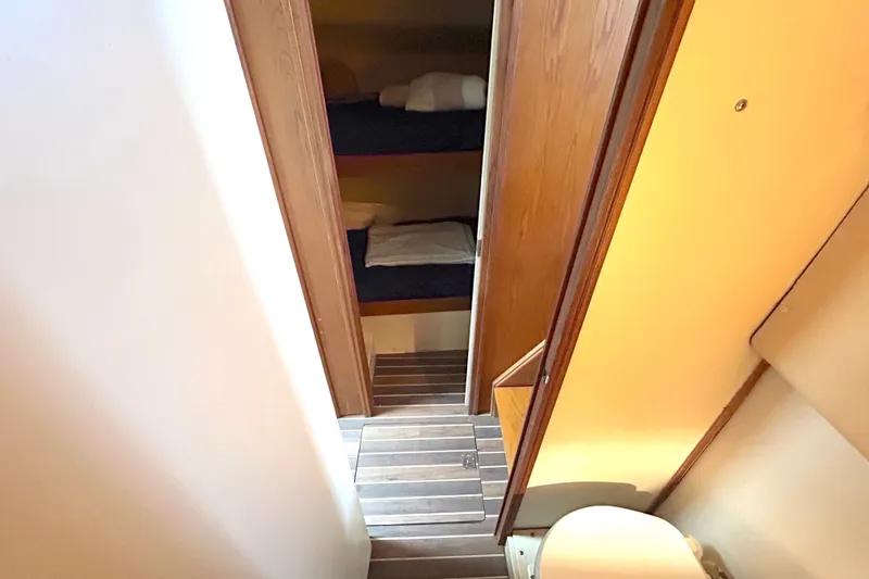 Slide: The Image of Interior of 1990 Bertram 37 Convertible yacht showing bunk beds and bathroom. - 33