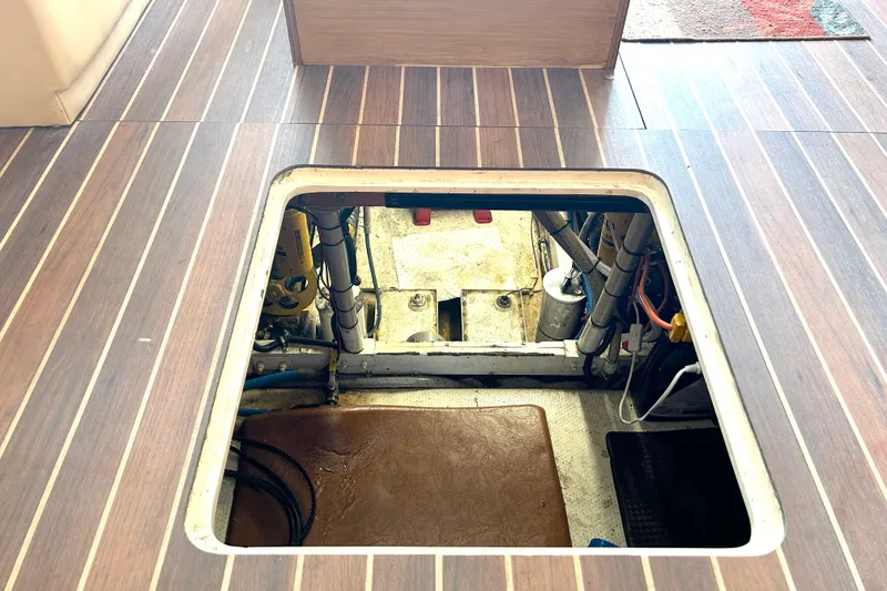 Slide: The Image of Engine compartment of a 1990 Bertram 37 Convertible yacht, viewed through floor hatch. - 36
