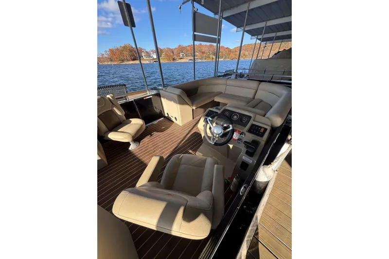 Slide: The Image of Interior of 2020 Crest Classic LX 220 L pontoon boat with beige seating and steering console. - 3