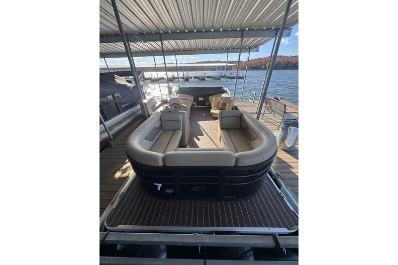 Slide: The Image of 2020 Crest Classic LX 220 L pontoon boat docked on a sunny day. - 1