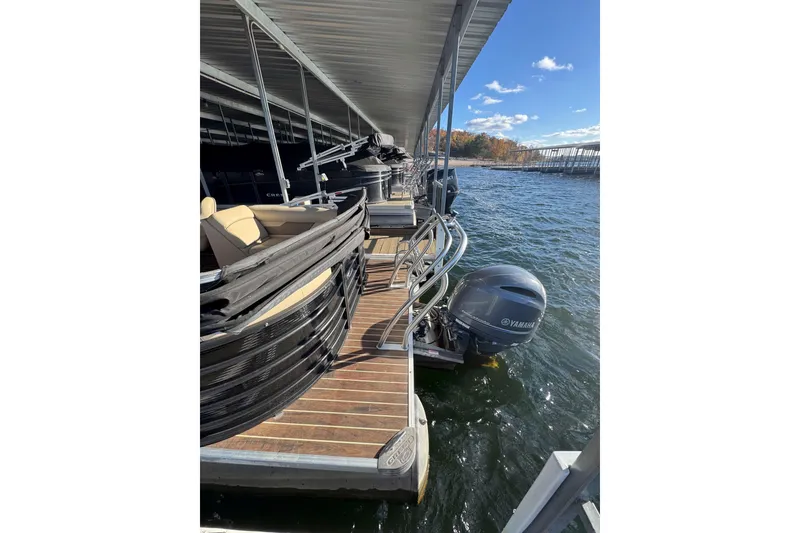 Slide: The Image of 2020 Crest Classic LX 220 L pontoon boat docked with Yamaha outboard motor. - 5