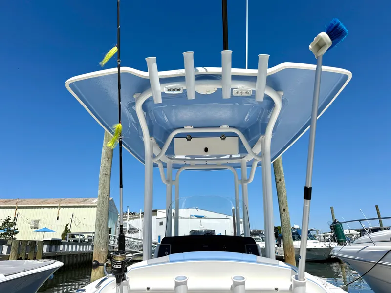 Slide: The Image of The image shows the T-top of a Robalo R232 Explorer boat with fishing rod holders. - 7