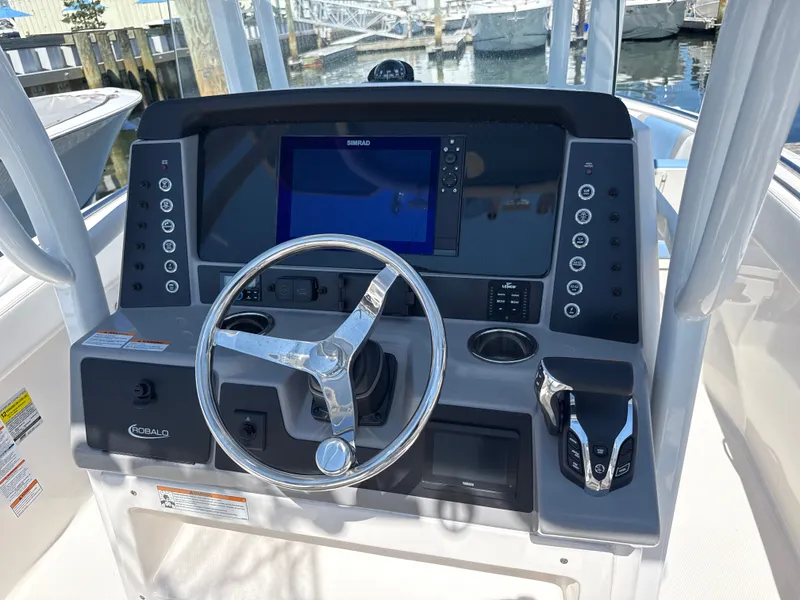 Slide: The Image of The image shows the helm of a 2025 Robalo R232 Explorer boat with a modern display. - 9