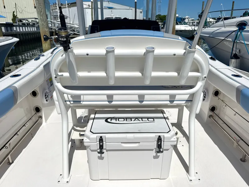 Slide: The Image of The image shows the cockpit of a 2025 Robalo R232 Explorer with rod holders and a cooler. - 6