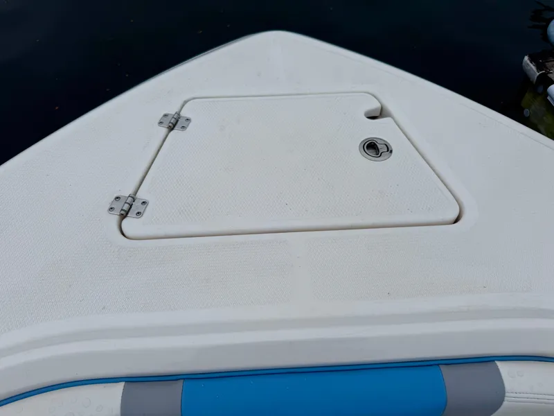 Slide: The Image of The image shows the bow deck of a Robalo R232 Explorer boat with an access hatch. - 14