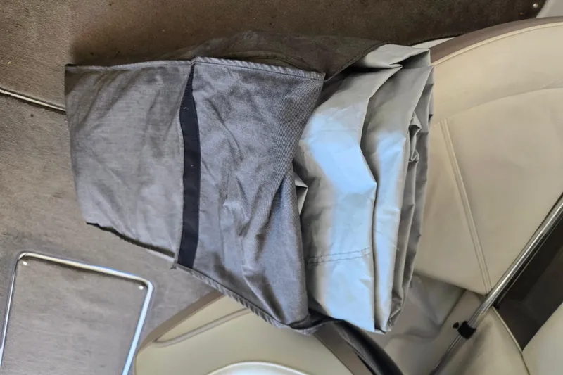 Slide: The Image of Folded boat cover on Cobalt 250, 2005 model, resting on beige seat. - 17