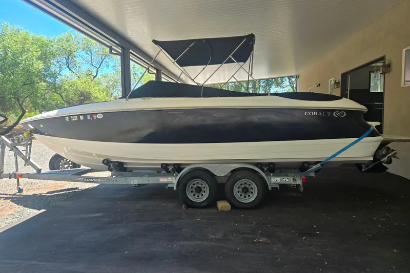 Slide: The Image of 2005 Cobalt 250 boat on trailer under covered area, side view. - 1