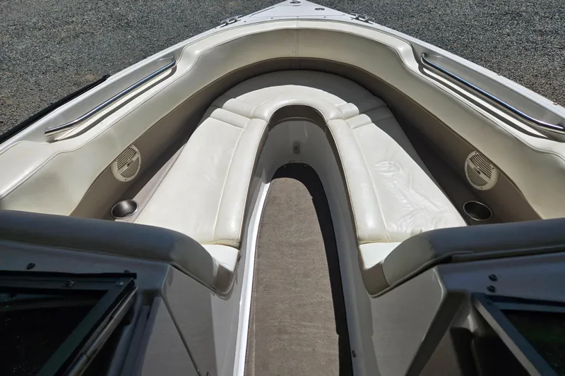 Slide: The Image of Interior view of a 2005 Cobalt 250 boat with white seating and carpeted floor. - 8