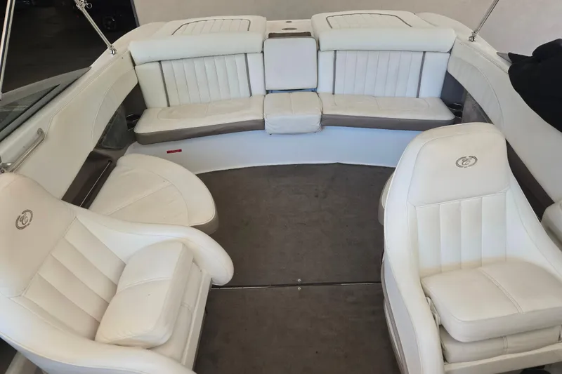 Slide: The Image of Interior of a 2005 Cobalt 250 boat with white leather seating. - 9