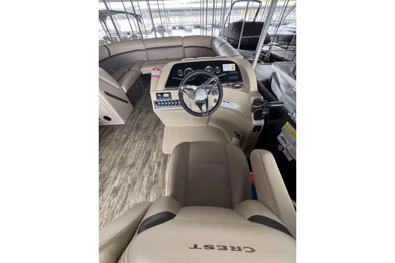 Slide: The Image of 2023 Crest Classic LX 220 boat interior with steering wheel and seating. - 4