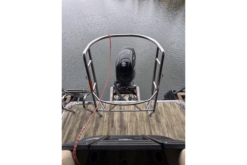 Slide: The Image of 2023 Crest Classic LX 220 boat with outboard motor on a wooden deck. - 10