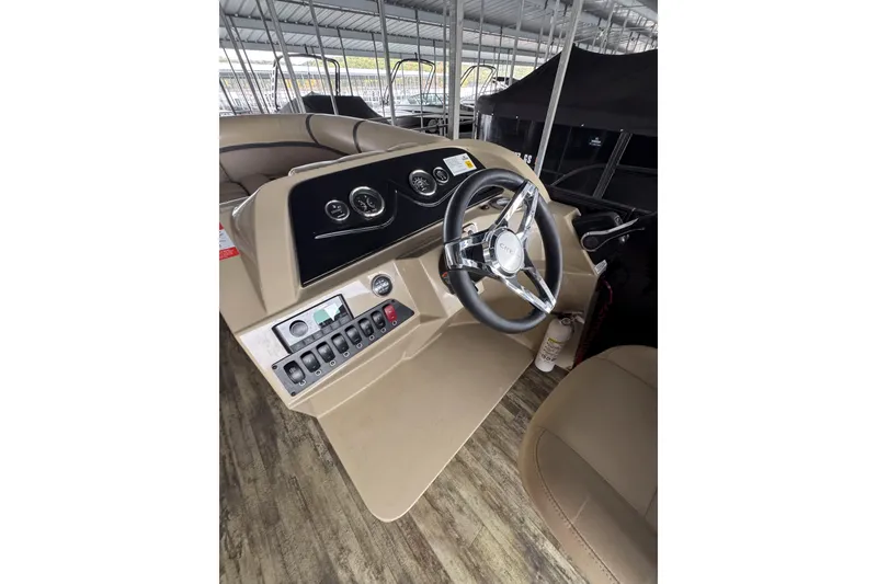 Slide: The Image of 2023 Crest Classic LX 220 boat dashboard with steering wheel and control panel. - 5