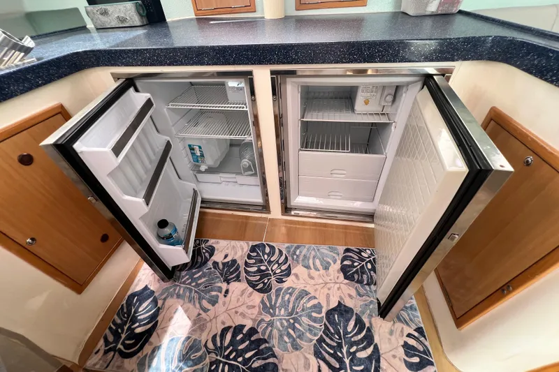 Slide: The Image of Open refrigerators in the kitchen of a 2008 Admiral 40 Cruiser yacht. - 44