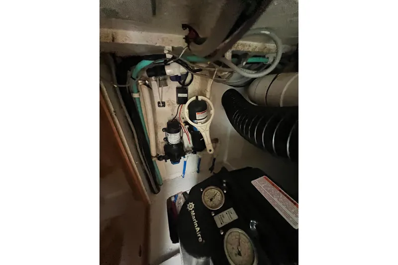 Slide: The Image of Engine compartment of a 2008 Admiral 40 Cruiser with visible hoses and gauges. - 82