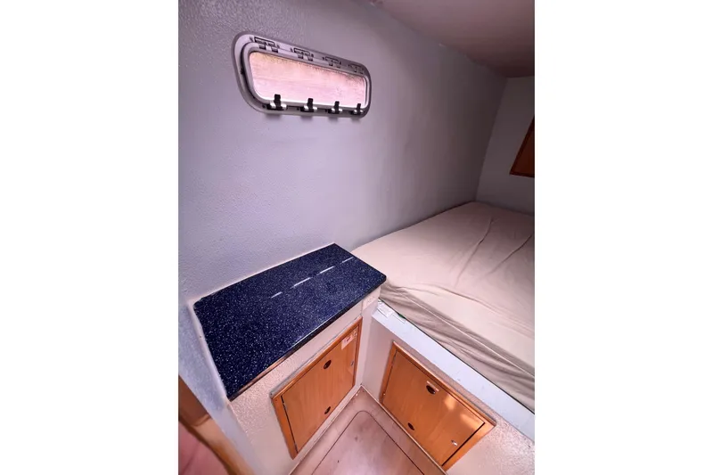 Slide: The Image of Interior cabin of 2008 Admiral 40 Cruiser with bed, window, and storage cabinets. - 88
