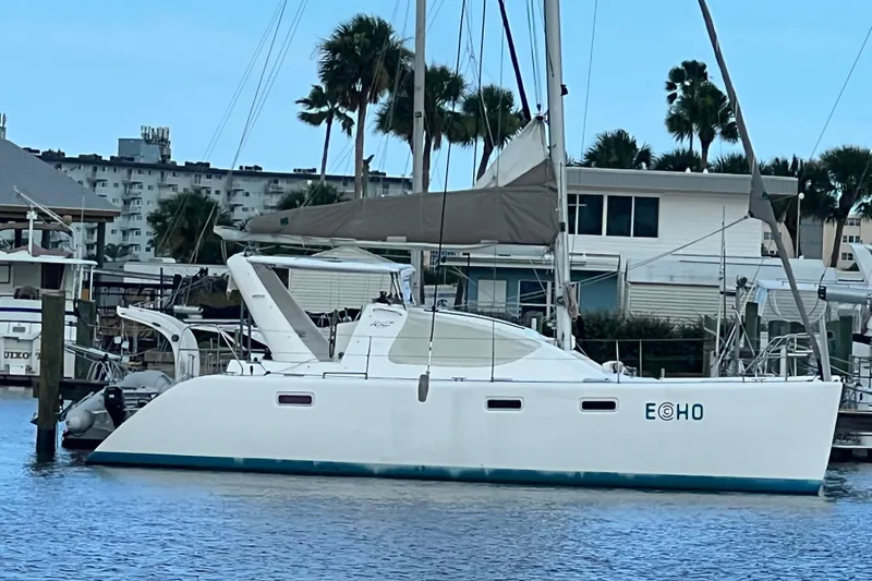 The Image of 2008 Admiral 40 Cruiser sailboat docked at marina with palm trees in background. - 0