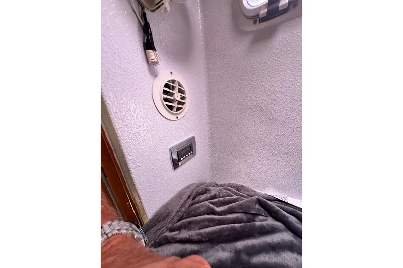 Slide: The Image of Interior of 2008 Admiral 40 Cruiser with vent, control panel, and gray blanket. - 60