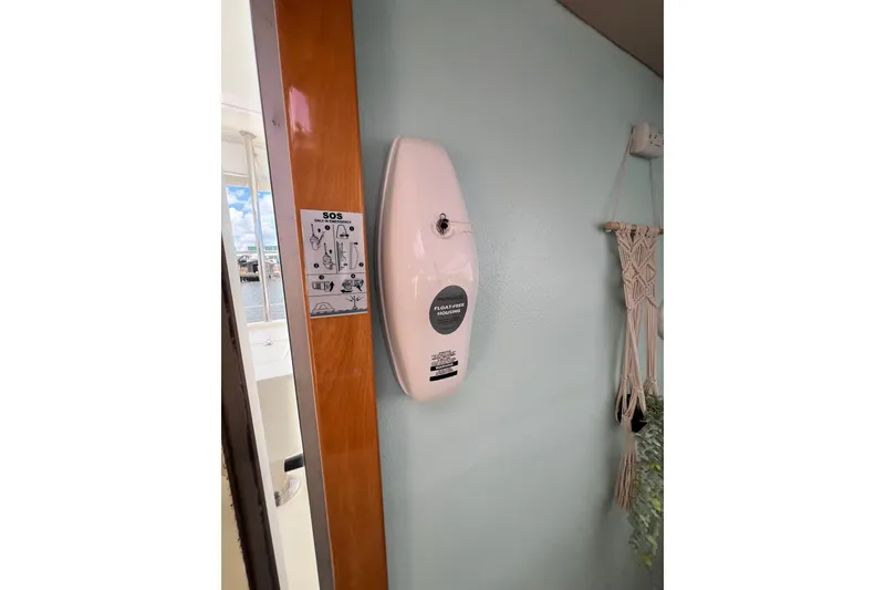 Slide: The Image of Wall-mounted air freshener and SOS instructions on Admiral 40 cruiser, 2008 model. - 47