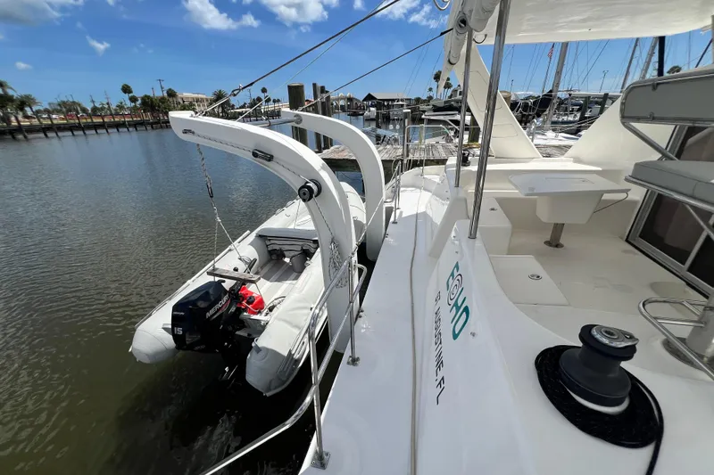 Slide: The Image of 2008 Admiral 40 Cruiser yacht with dinghy, docked at marina under blue sky. - 33