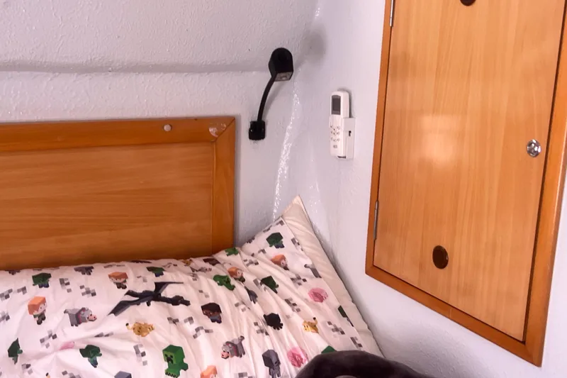 Slide: The Image of Cozy cabin interior of 2008 Admiral 40 cruiser with wooden paneling and playful bedding. - 59