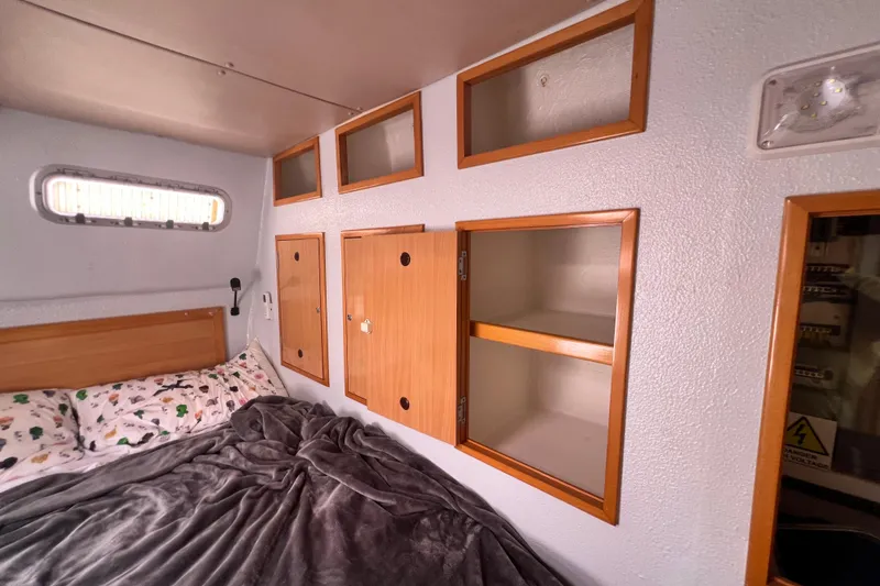 Slide: The Image of Cozy cabin interior of 2008 Admiral 40 cruiser with wooden storage and bed. - 58